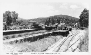Tramway train (right) being unloaded at the Yarra Junction sidings.
