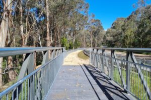 The Yackandandah Rd has used the old rail formation for a short distance requiring this boardwalk. [Chris Kinniard 2021]