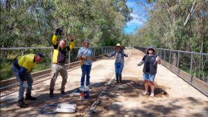 A lot of the features of the High Country Rail Trail have been built by volunteers. Rotary volunteers work on handrails for the next section across the Murray River flood plains at Wodonga [2021]