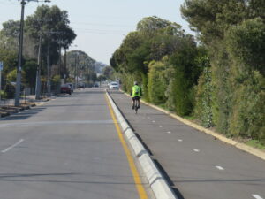 separated bike lanes with vegetation screening the train line - Oct 2020
