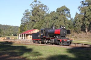 Historic steam locomotive besides replica railway station created by community [2014]